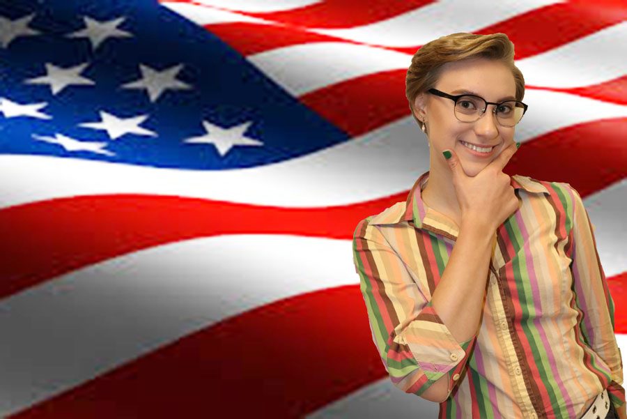 Karen Larionova looks smug in front of an American flag.