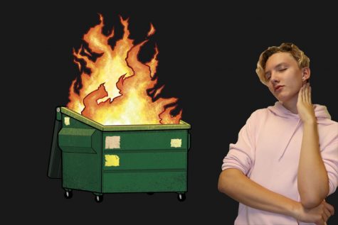 Nick Walfrid is posing next to a burning dumpster.